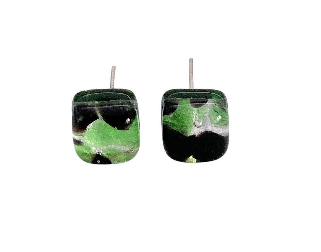 Murano Passion’s Murano Glass Earrings (MGE1) feature a dainty 8mm round design with green, black, and white abstract swirls. These handmade earrings have a glossy finish and are set against a plain white background.