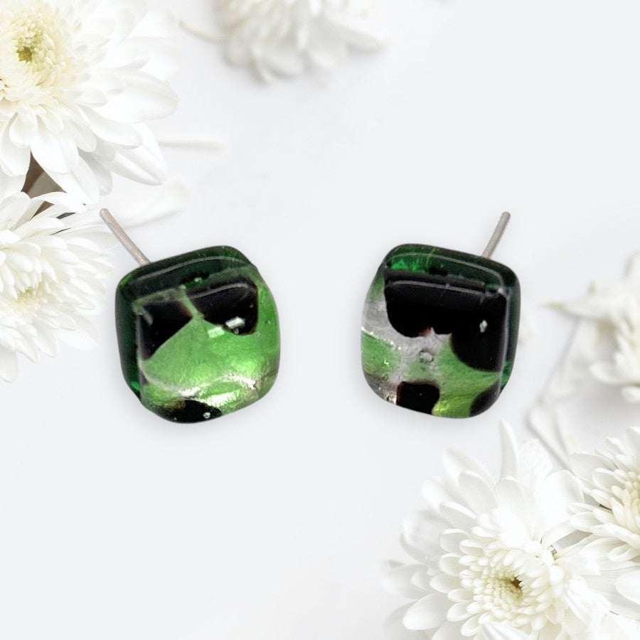 Murano Passion Murano Glass Earrings (MGE1) in green and black, dainty 8mm square design, are displayed on a white surface with white chrysanthemum flowers.
