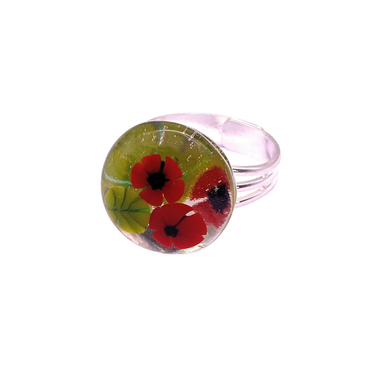 The Calon Glass Poppy Ring (CGR8) features a handmade glass round top with red poppy flowers and green leaves, inspired by millefiori designs—a unique flower ring blending artistry and elegance.