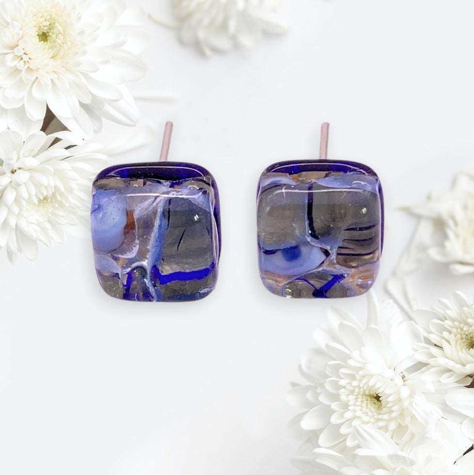 Murano Passion’s Murano Glass Earrings - Blue/Gold (MGE15), dainty 8mm rounds, feature stunning handmade abstract patterns and are beautifully displayed with white chrysanthemums.