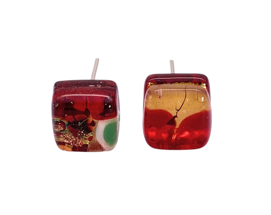 Murano Passion’s Murano Glass Earrings (MGE9) feature dainty 8mm red and gold studs, each with unique swirls and bubbles, set on silver posts against a white background.