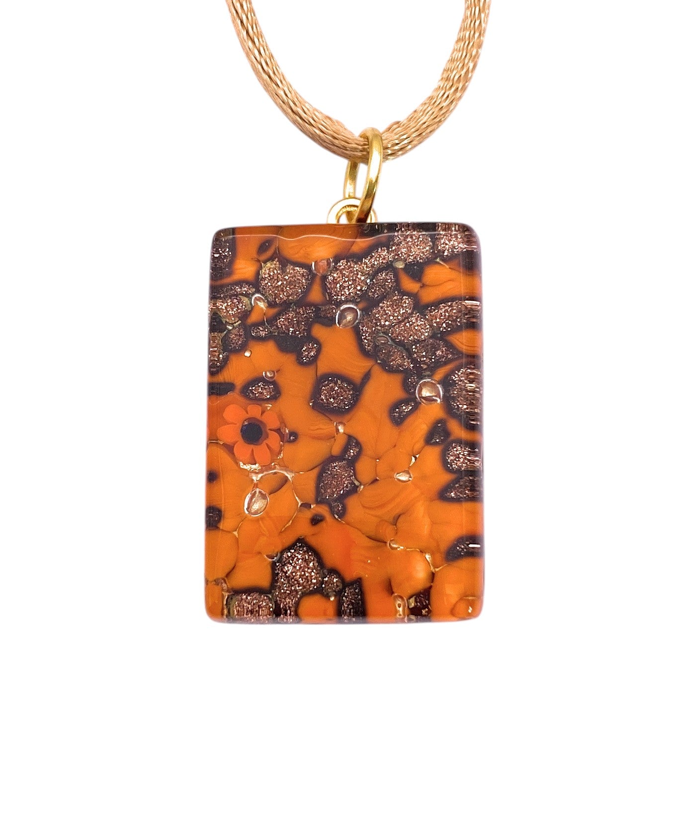 The Murano Passion "Murano Glass Pendant with Glitter on Gold Leaf - 3cm x 2cm (MGPC7)" features a rectangular design with orange and dark brown speckles, glittery accents, a tiny red flower, and comes with a Certificate of Authenticity.