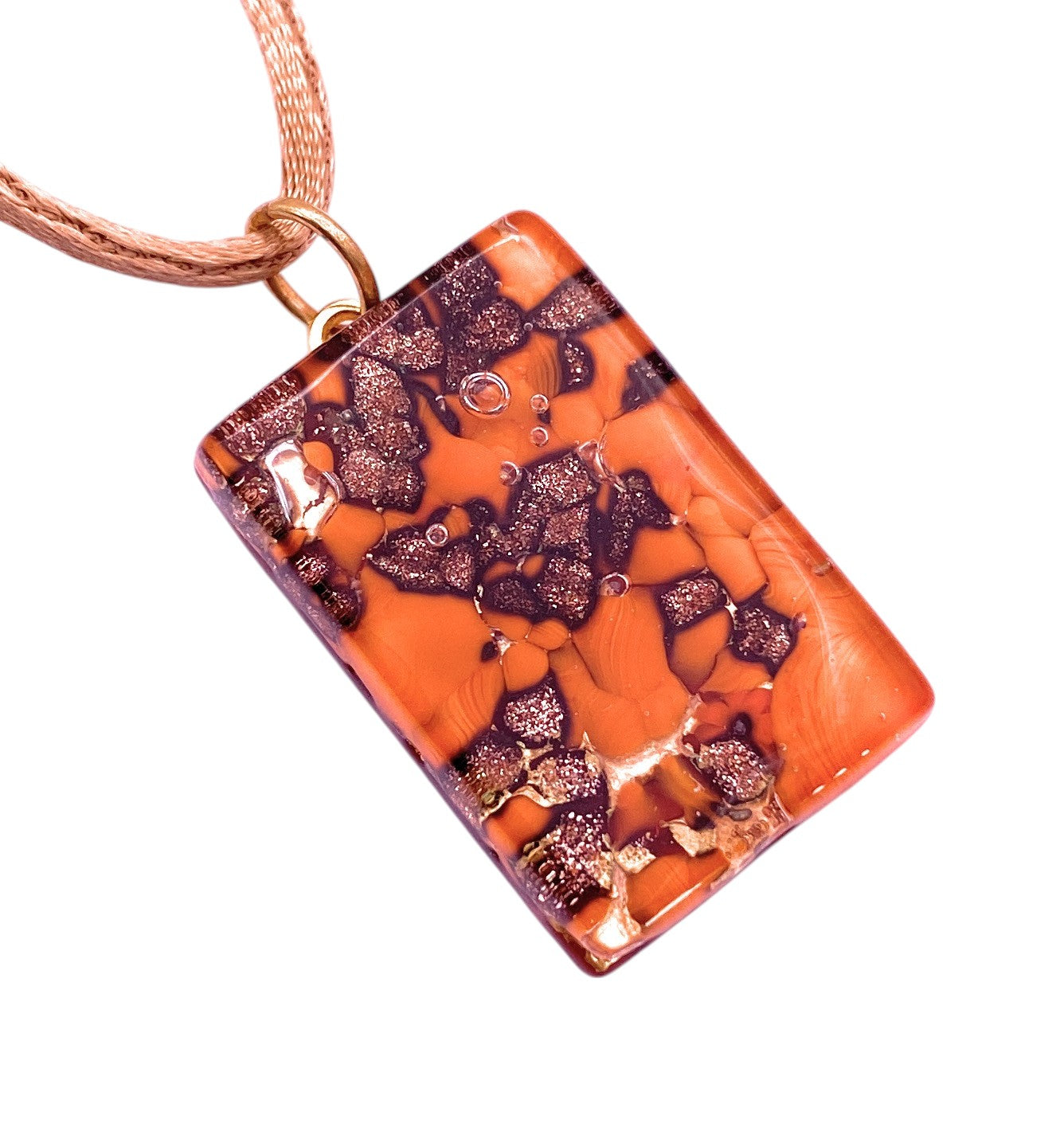 The Murano Passion "Murano Glass Pendant with Glitter on Gold Leaf - 3cm x 2cm (MGPC7)" features an orange base with metallic purple and copper flakes, inspired by Murano Glass Jewellery, on a light rose-gold chain.