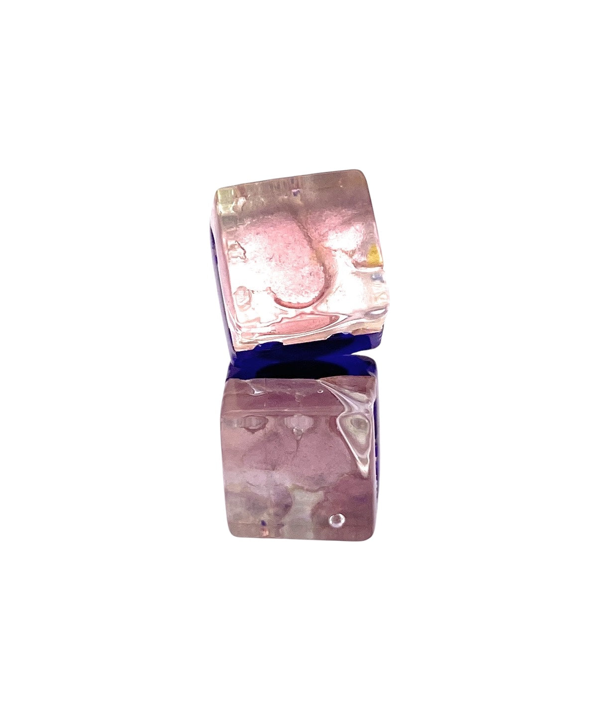 Two shiny metallic dice, reminiscent of Murano Passion's Pale Pink/Silver 8mm Murano Glass Earrings, display a mix of pink, purple, and blue hues as they stack against a plain white background.
