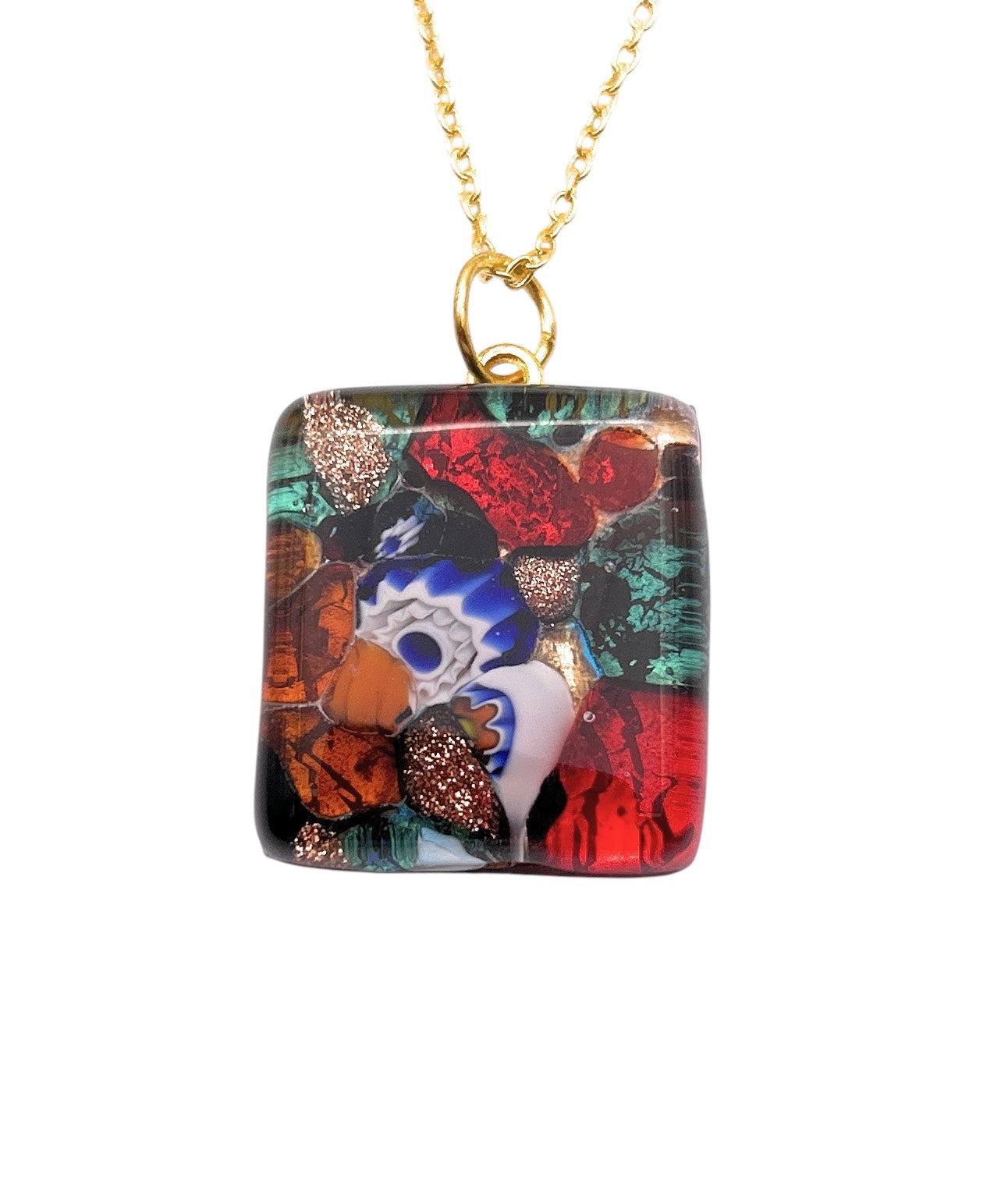 The Murano Passion WEBSITE EXCLUSIVE pendant features a colorful 2.3cm x 2cm Murano glass square crafted with Millefiori on gold leaf, hanging from a gold chain. Complete with a Certificate of Authenticity, it boasts vibrant patterns in red, blue, white, and green with glistening gold accents.