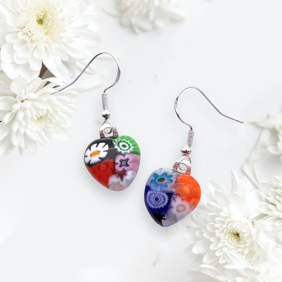 Murano Passion presents Millefiori Murano Glass Earrings featuring vibrant red, blue, and purple floral patterns on white. These dainty 1.4cm x 1.3cm heart-shaped treasures in 925 sterling silver echo Venice's timeless elegance.