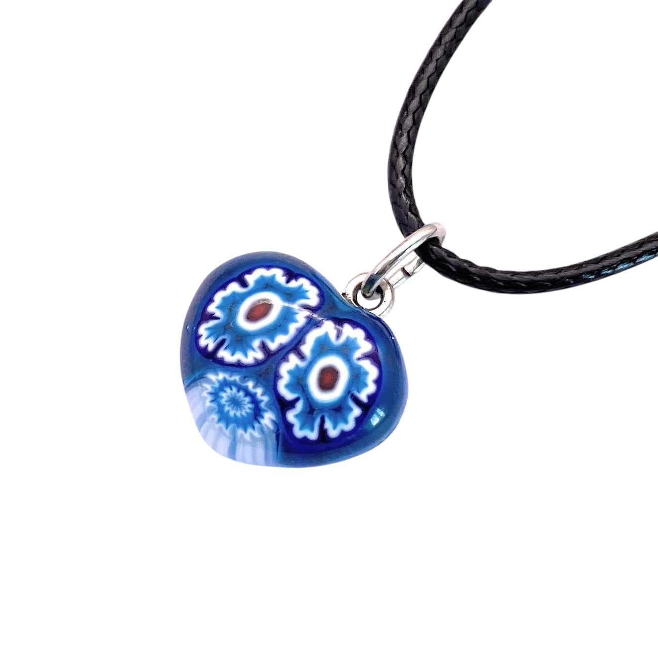The Murano Passion's Murano Glass Pendant, featuring intricate blue, white, and red floral designs, elegantly hangs from a black cord and comes with a Certificate of Authenticity, highlighting its unique craftsmanship. This exquisite piece is the tiny 1.4cm Murano Heart Pendant (MHT1).