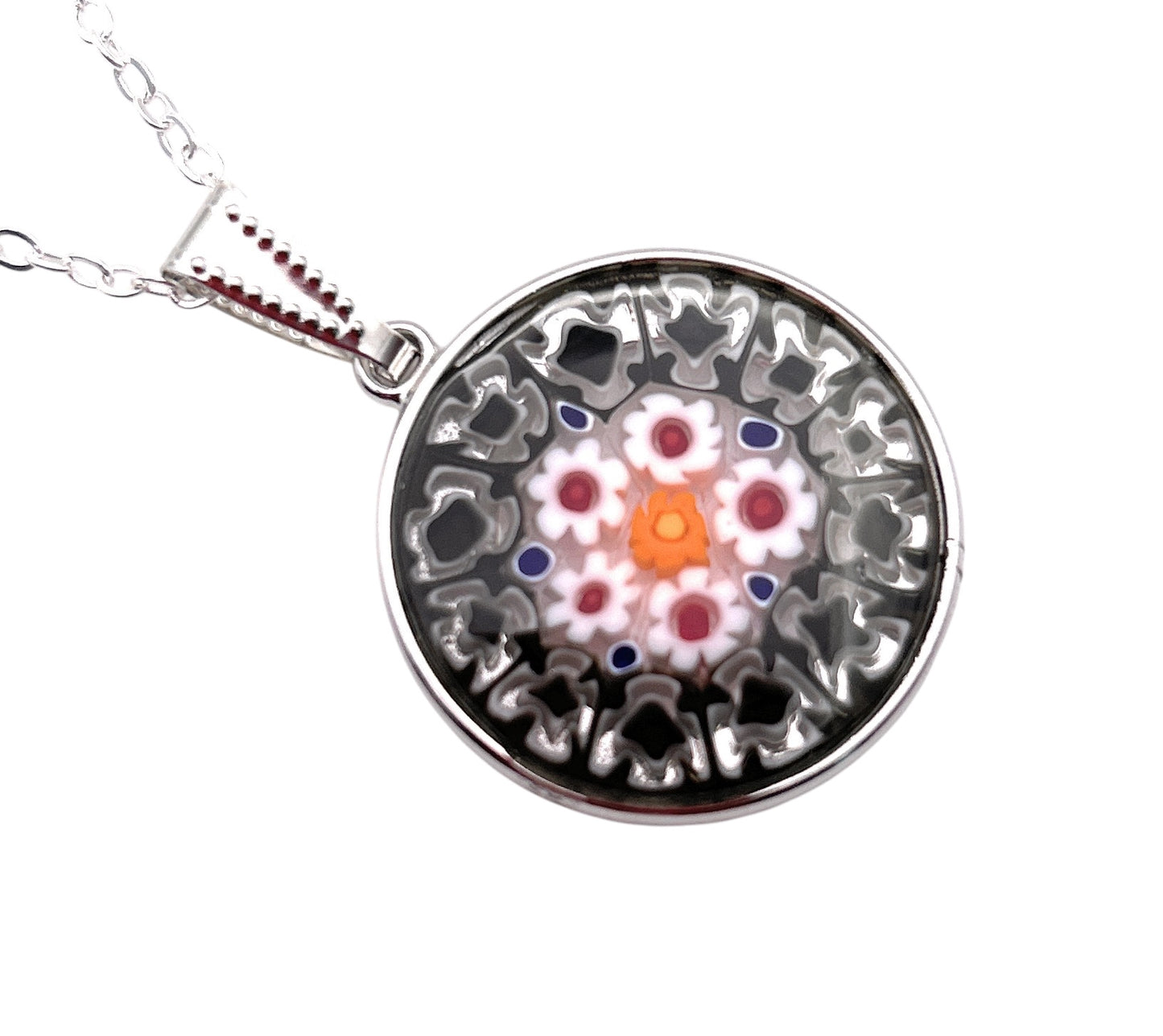 The 2.4cm Murano Passion Glass Pendant showcases an intricate floral design in red, pink, and orange on a gray background, elegantly hanging from a silver chain. This genuine piece includes a Certificate of Authenticity from Murano Passion.