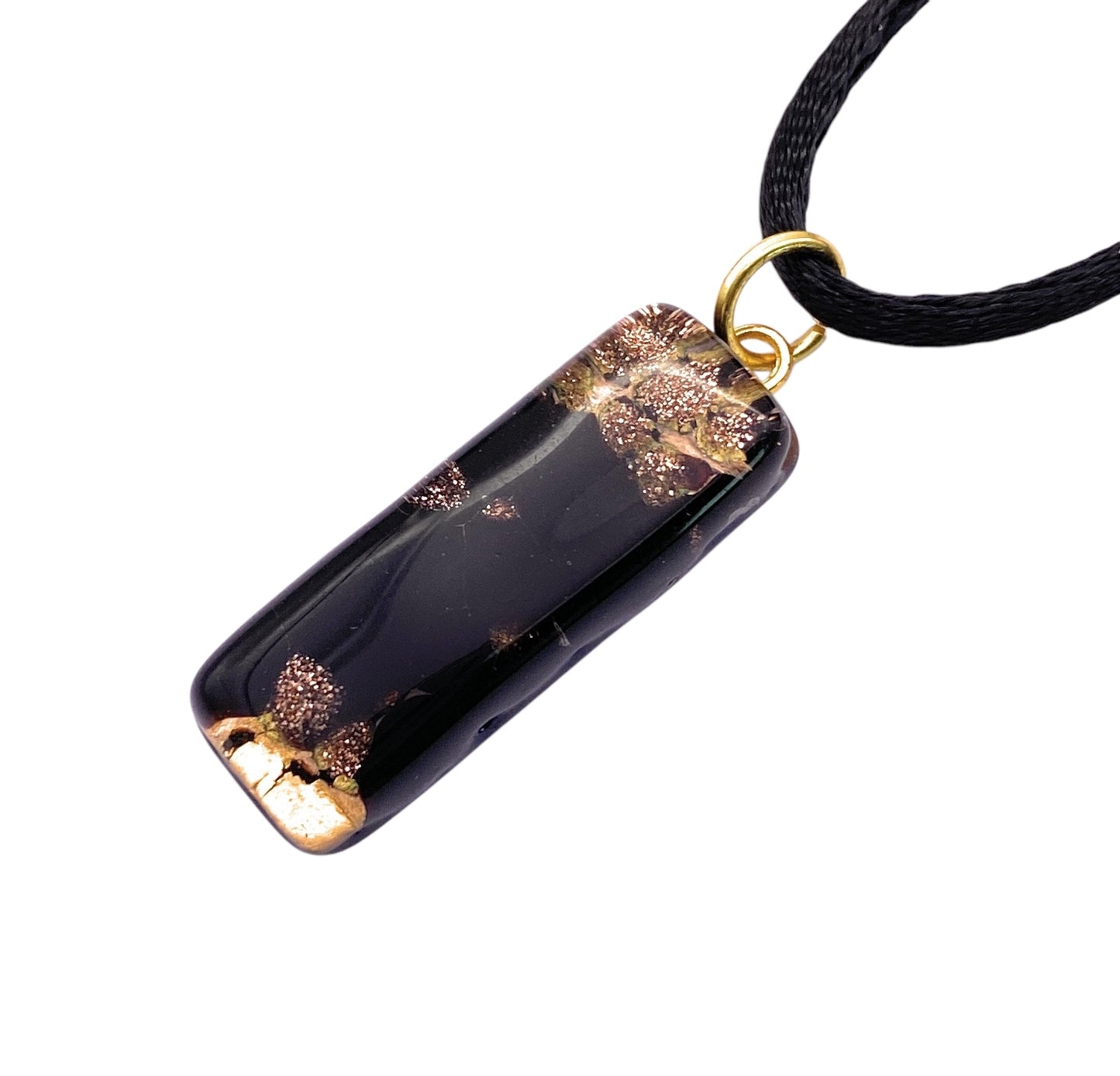 The Murano Passion MGPL5 features a 3cm x 1cm rectangular Murano glass pendant with gold leaf on a thin black cord and small gold loop. Its smooth, glossy surface reflects light, showcasing its elegant handmade design.
