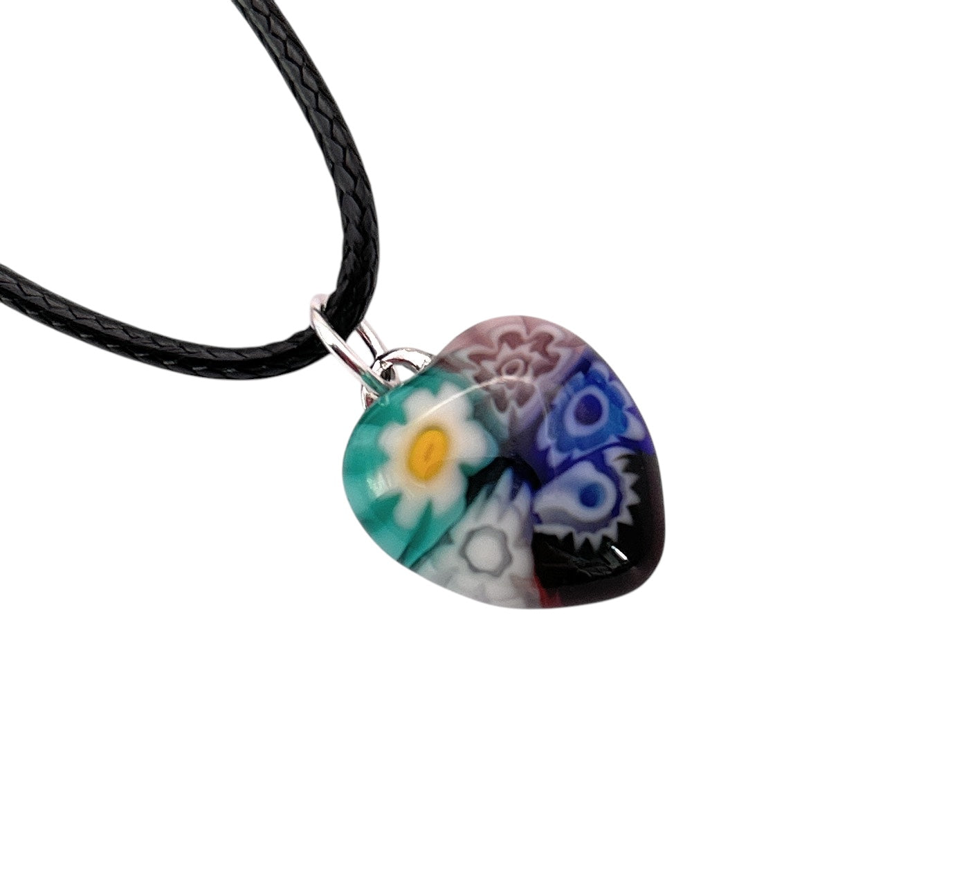 The Murano Heart Pendant by Murano Passion features vivid millefiori patterns in blue, green, purple, and red and hangs on a black braided leather cord with a silver loop. It comes with a Certificate of Authenticity to guarantee genuine craftsmanship. (Product: Tiny MHT3).