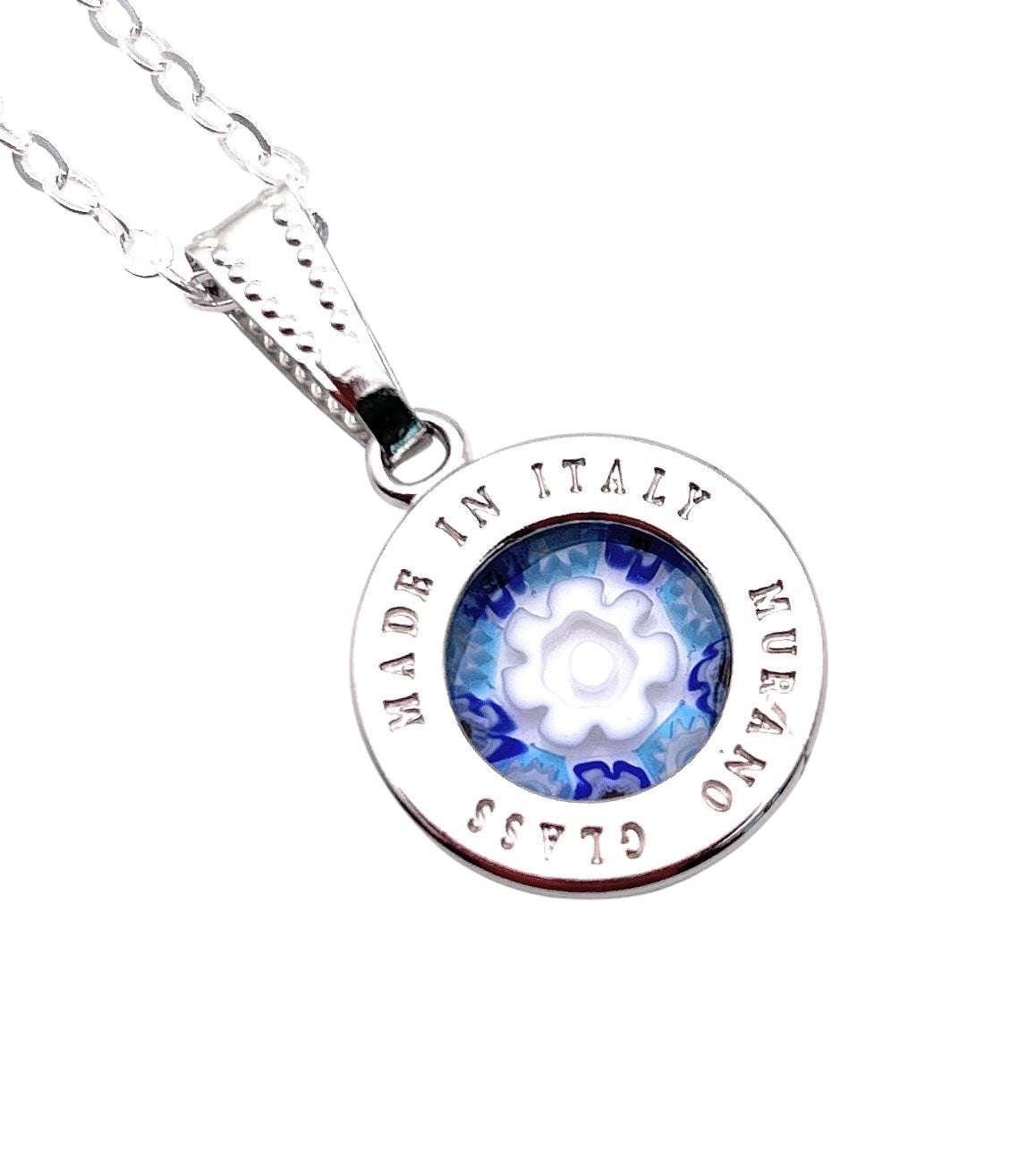 The Murano Passion Pendant features Millefiori flowers in blue and white, set in a circular silver frame inscribed "Made in Italy Murano Glass." This 1.5cm dainty piece elegantly hangs from a silver chain, epitomizing fine Murano Glass Jewellery.