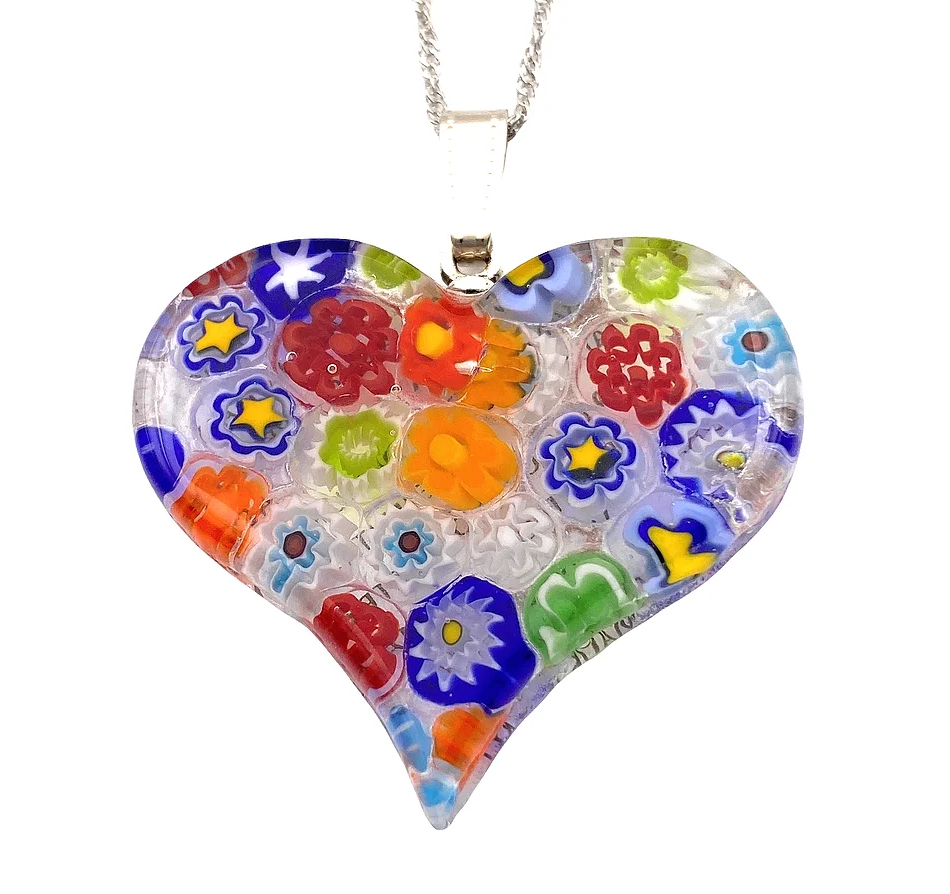 This exquisite Murano Passion Millefiori Heart Pendant, measuring 4cm by 3.5cm, features a vibrant pattern of colorful flowers and stars, elegantly suspended on a silver chain. It represents the finest in Murano Glass Jewelry, with each piece including a Certificate of Authenticity for your assurance.