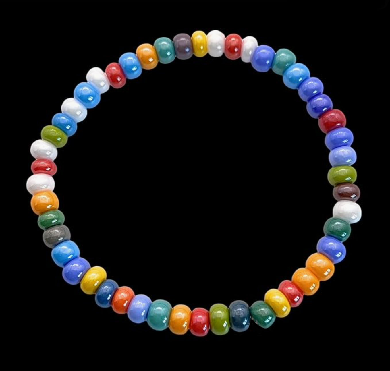 Introducing the Murano Passion Murano Glass Beaded Bracelet (MGBR2), featuring dainty 5mm multi-colored beads in vibrant red, blue, green, yellow, white, and orange hues elegantly arranged against a black backdrop on an elasticated band.