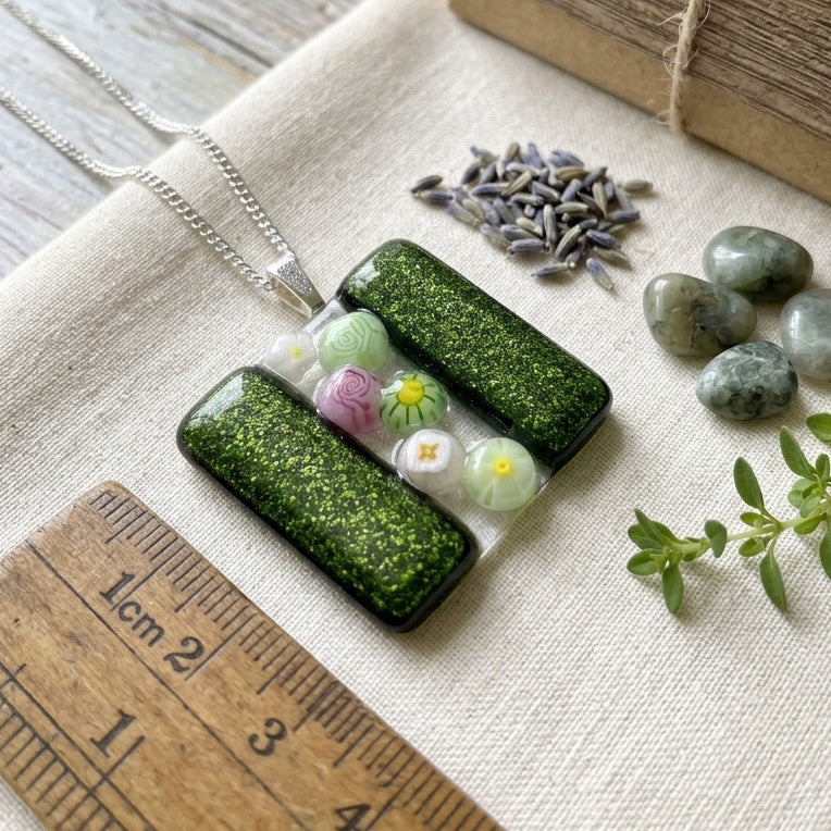Handmade Glass Pendant made with Millefiori Glass Flowers - 3cm x 3cm (Emerald Green) shown with a wooden ruler.