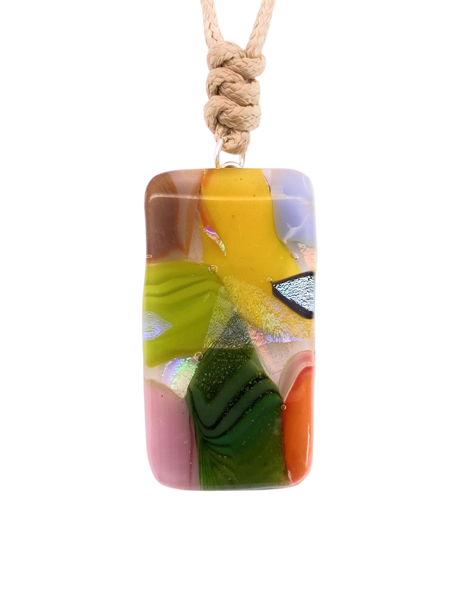 The Handmade Dichroic Glass Mosaic Pendant – Multicolour Fused Glass Statement Necklace (CGP82) by Calon Glass features a rectangular piece of vibrant fused glass, showcasing abstract mosaic patterns in yellow, green, purple, pink, and orange. Suspended from a knotted beige cord, this handcrafted pendant infuses any outfit with a unique and colorful flair.