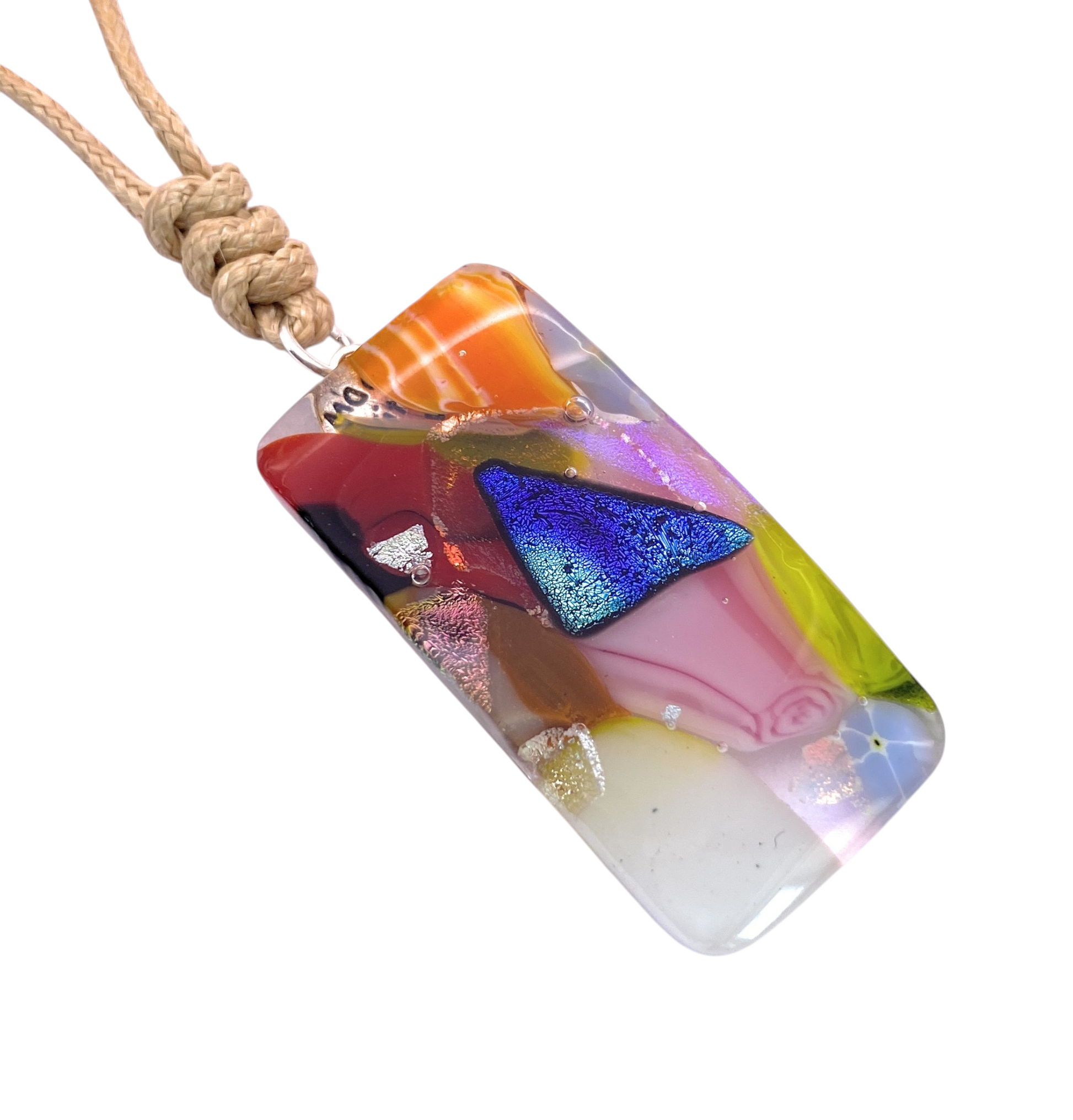 Introducing the Handmade Dichroic Glass Mosaic Pendant – Multicolour Fused Glass Statement Necklace (CGP84) by Calon Glass: a rectangular, handcrafted piece adorned with vibrant abstract patterns and a bold blue metallic triangle, suspended from a tan knotted cord—making it an eye-catching accessory for lovers of unique multicoloured jewellery.