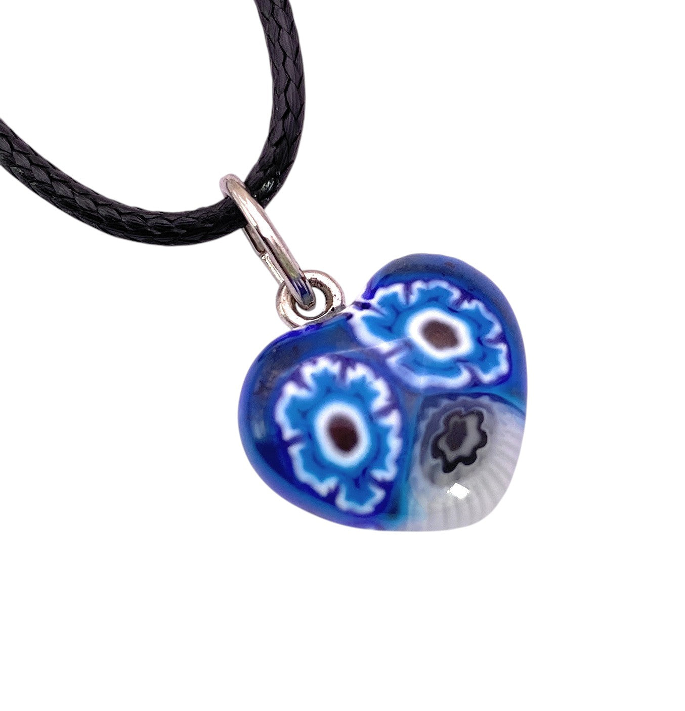 The Murano Passion Murano Heart Pendant (Tiny 1.4cm, MHT6) is a heart-shaped blue jewellery piece featuring intricate white and blue eye patterns, inspired by the artistry of Venice, Italy, and suspended on a black cord necklace.