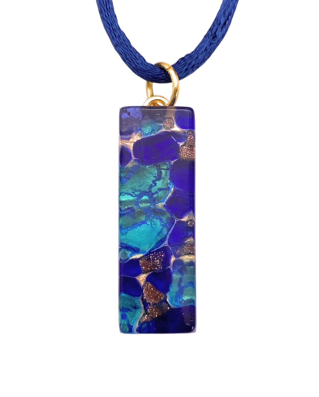 The Murano Passion Murano Glass Pendant with Blue on Gold Leaf (3cm x 1cm, MGPL11) features a striking rectangular design in blue and gold, hanging elegantly from a blue cord with a small gold ring.