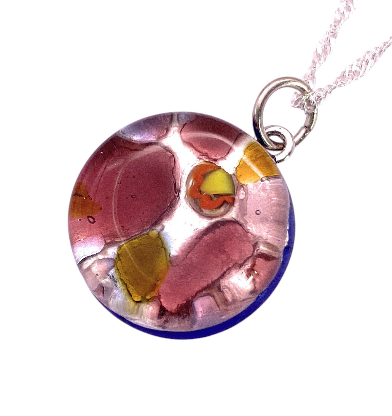 The Murano Passion Murano Glass Round Pendant (MGPV1) features vibrant abstract Millefiori patterns in pink, yellow, orange, and blue on a glossy 2cm surface, inspired by Venice and complete with a silver loop and chain.