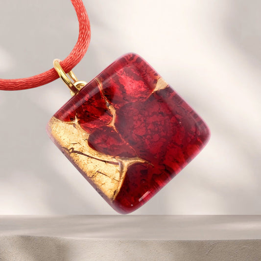 Murano Glass Pendant - Red on Gold Leaf, 2cm x 2cm (MGPD2): a square red pendant with embedded gold leaf on a red cord.