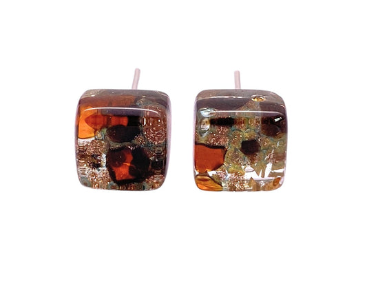 Murano Passion’s Murano Glass Earrings - Multi on Gold (MGE1) feature dainty 8mm square studs with an abstract amber, gold, and black pattern on white. Handmade artistry makes these genuine Murano pieces truly unique.