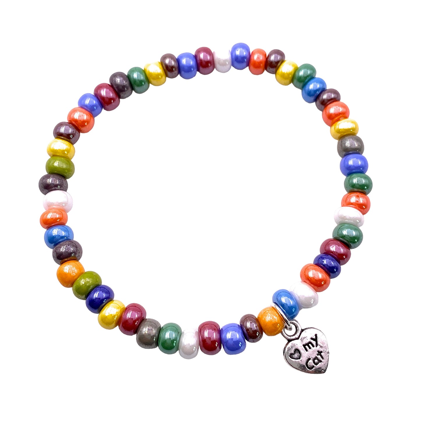 The Murano Passion bracelet, known as the Murano Glass Beaded Bracelet with Cat Charm (MGBR5), is a vibrant piece of handmade jewelry featuring dainty 5mm multi-colored beads in red, yellow, green, blue, orange, and white. It includes an elasticated band and a silver heart-shaped charm engraved with "Et cat," adding a unique touch to this exquisite piece.