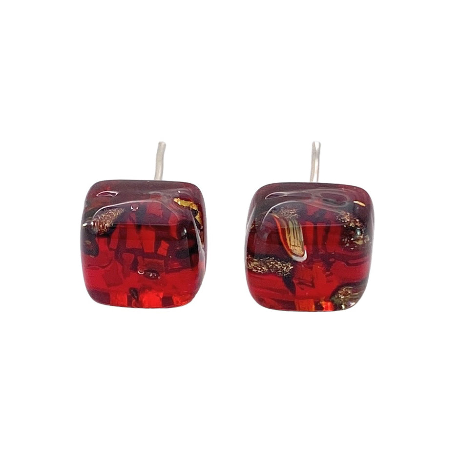 The Murano Glass Stud Earrings, Red on Gold Leaf, by Murano Passion exude Venetian artistic heritage with their intricate gold and black patterns. These dainty 0.8cm earrings are part of our Handmade Murano Jewelry collection and feature a glossy finish with swirling colors and textures.