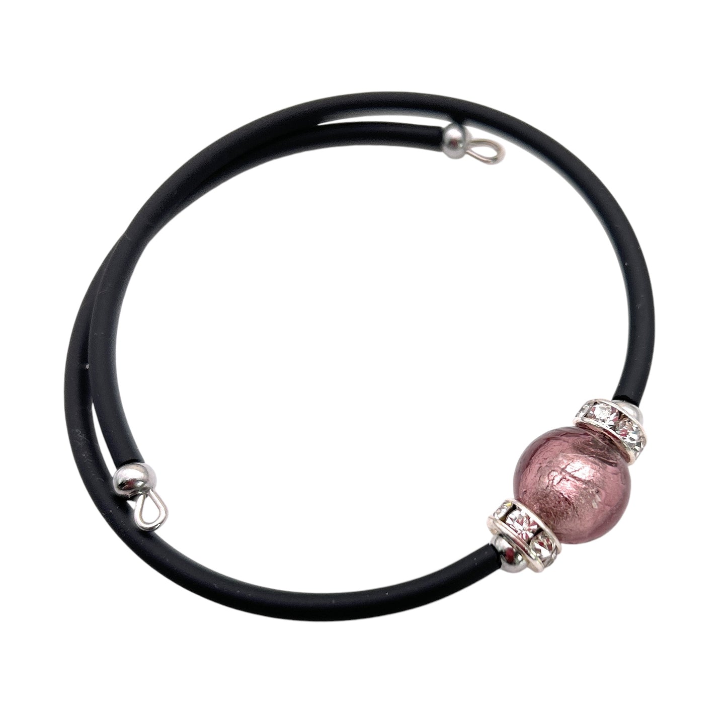 The Murano Passion Murano Glass Bead Bracelet is a chic black memory wire bracelet featuring a 1cm pink metallic Murano glass bead at its center, enhanced by silver decorative elements. Its handcrafted design ensures both elegance and comfort with a simplistic clasp.