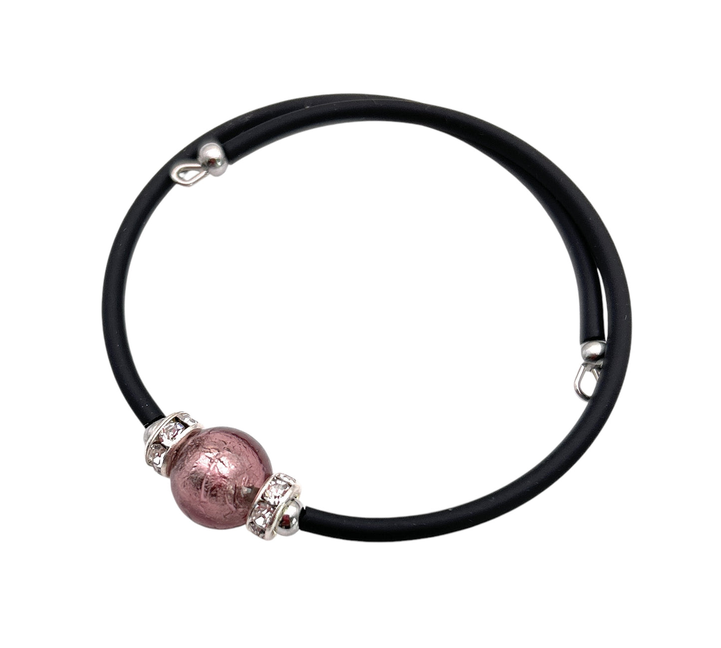 The Murano Passion memory wire bracelet showcases a sleek and contemporary charm with its minimalist design, featuring a 1cm Murano Glass bead in the center, adorned by small silver accents.