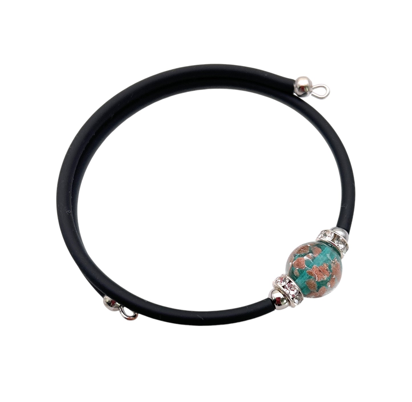 The Murano Passion memory wire bracelet from the Murano Glass Jewellery collection showcases a central 1cm turquoise and copper-colored patterned Murano glass bead, bordered by small metallic rings, with a simple clasp. Each piece includes a Certificate of Authenticity.