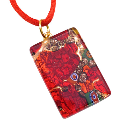 Here is a revised version of the sentence using the given product data:

The Murano Passion pendant, crafted with vibrant red Millefiori Murano Glass, showcases an abstract pattern with gold and multicolored accents. It hangs from a red cord featuring a gold loop. The design includes swirling shapes and boasts a glossy finish, arriving complete with a Certificate of Authenticity for genuine Murano Glass Jewellery. Dimensions: 3cm x 2cm.