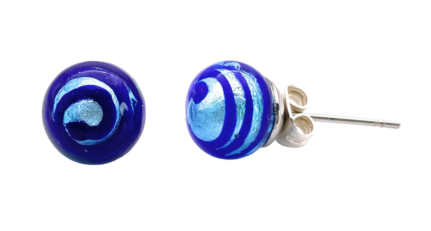 These Murano Glass Earrings (MGE12) by Murano Passion feature an 8mm round design, highlighted by a deep blue base adorned with swirling silver and lighter blue patterns. One earring elegantly displays the front design, while the other reveals a side view with a silver post and butterfly backing, exemplifying the exquisite craftsmanship of Murano artistry.