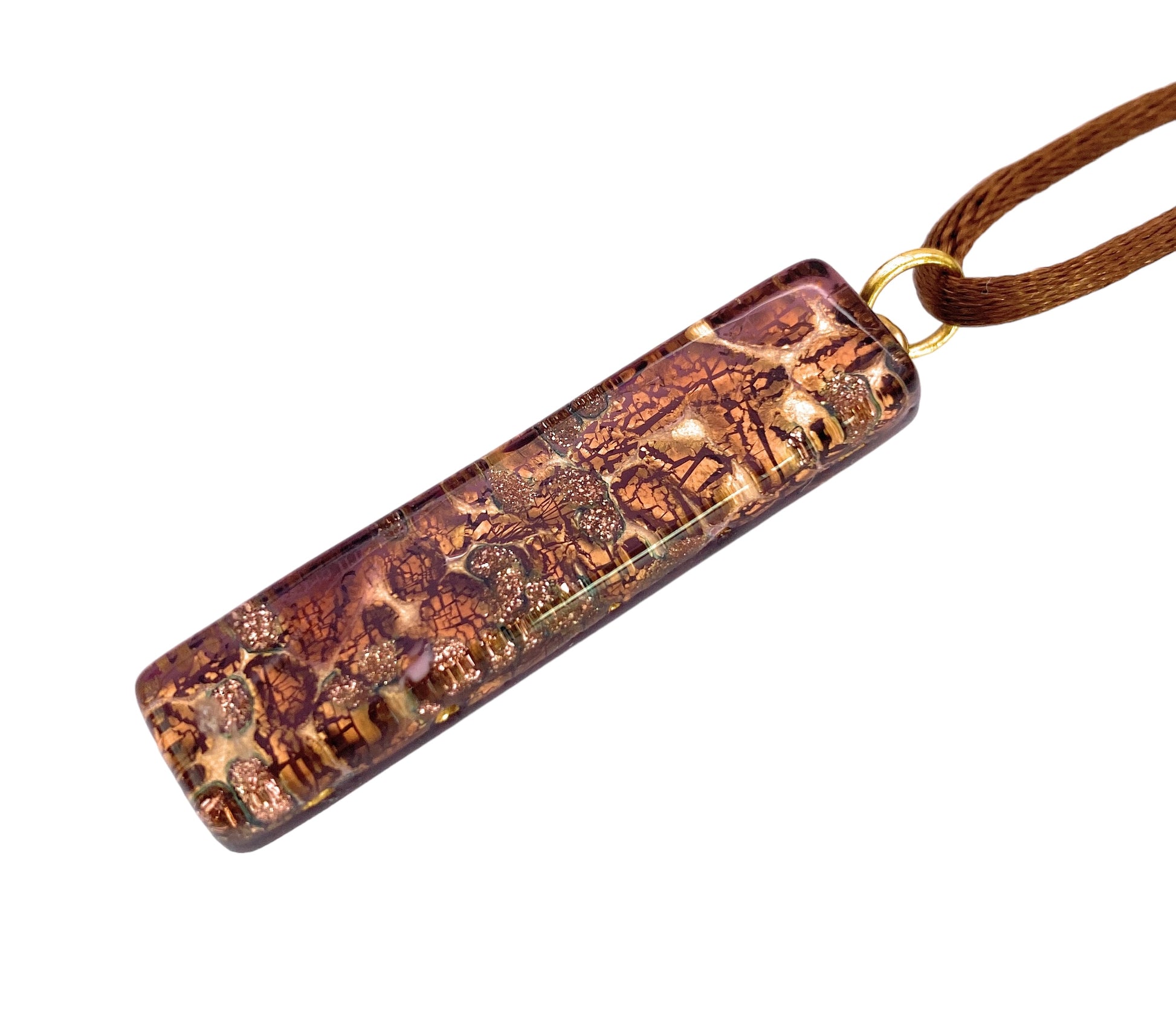 A Murano Passion pendant, crafted from Murano Glass and embellished with gold leaf, hangs gracefully from a brown cord. Measuring 4cm by 1cm, it showcases intricate maroon patterns and ornate textured details, exuding an elegant and artistic charm.