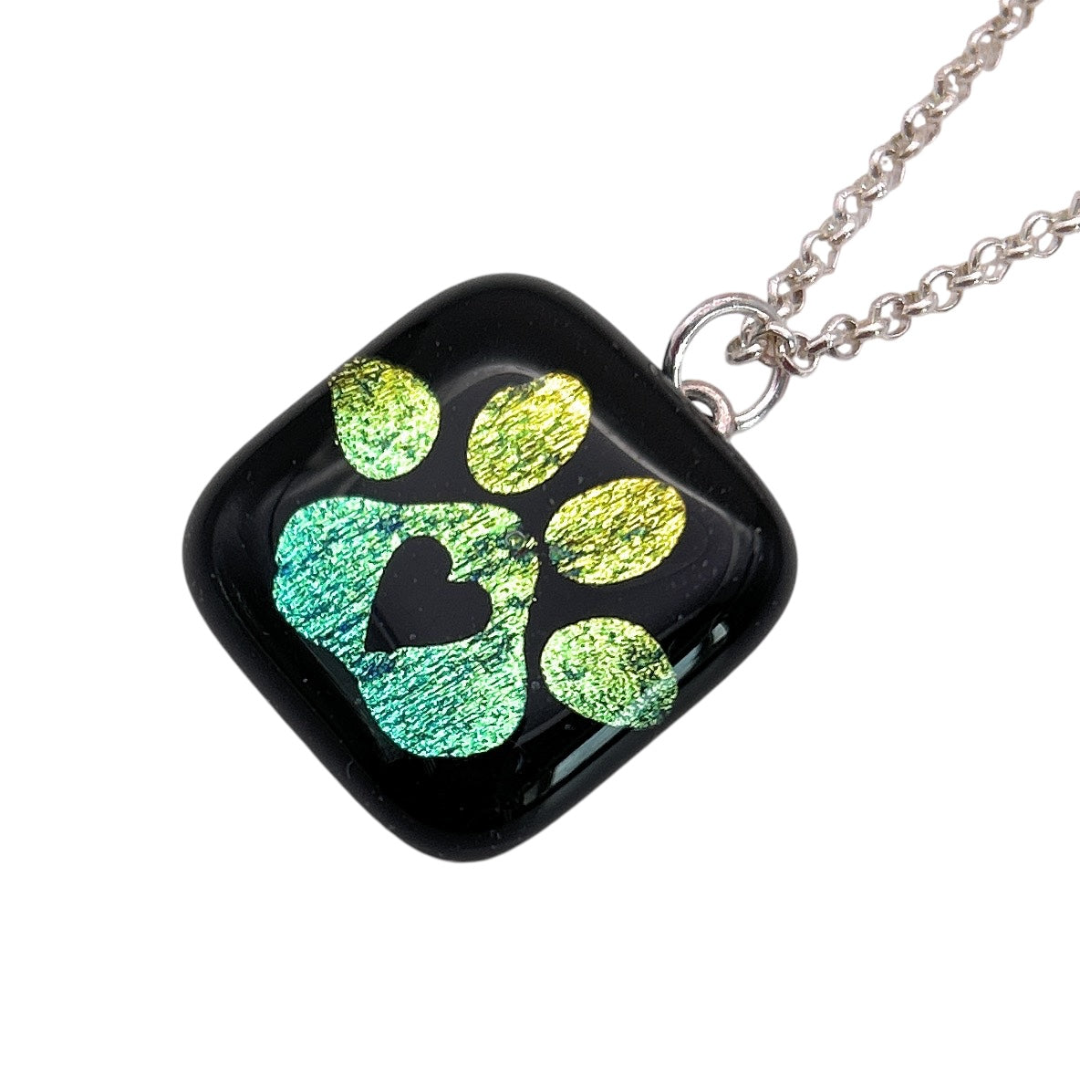 A pendant necklace features a green paw print design with a heart shape on black glass