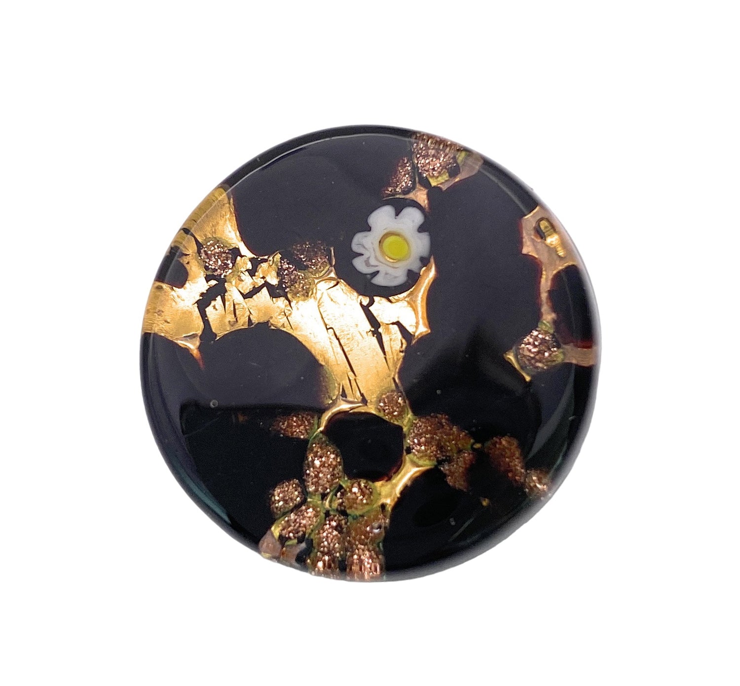 Product Description: The Murano Passion Murano Glass Brooch features a round, glossy black base adorned with streaks of metallic gold. A delicate white millefiori flower with a yellow center graces the top, providing a striking contrast to the dark background and gold accents. This piece beautifully reflects Venetian artistic heritage.