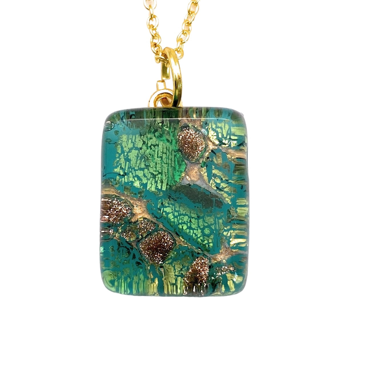 A rectangular Murano Passion glass pendant, measuring 2cm by 1.5cm, features a vibrant turquoise and gold pattern and hangs from a delicate gold chain. The design draws inspiration from Italian jewelry with abstract leaf-like shapes and shimmering textures, resulting in an elegant and artistic appearance.