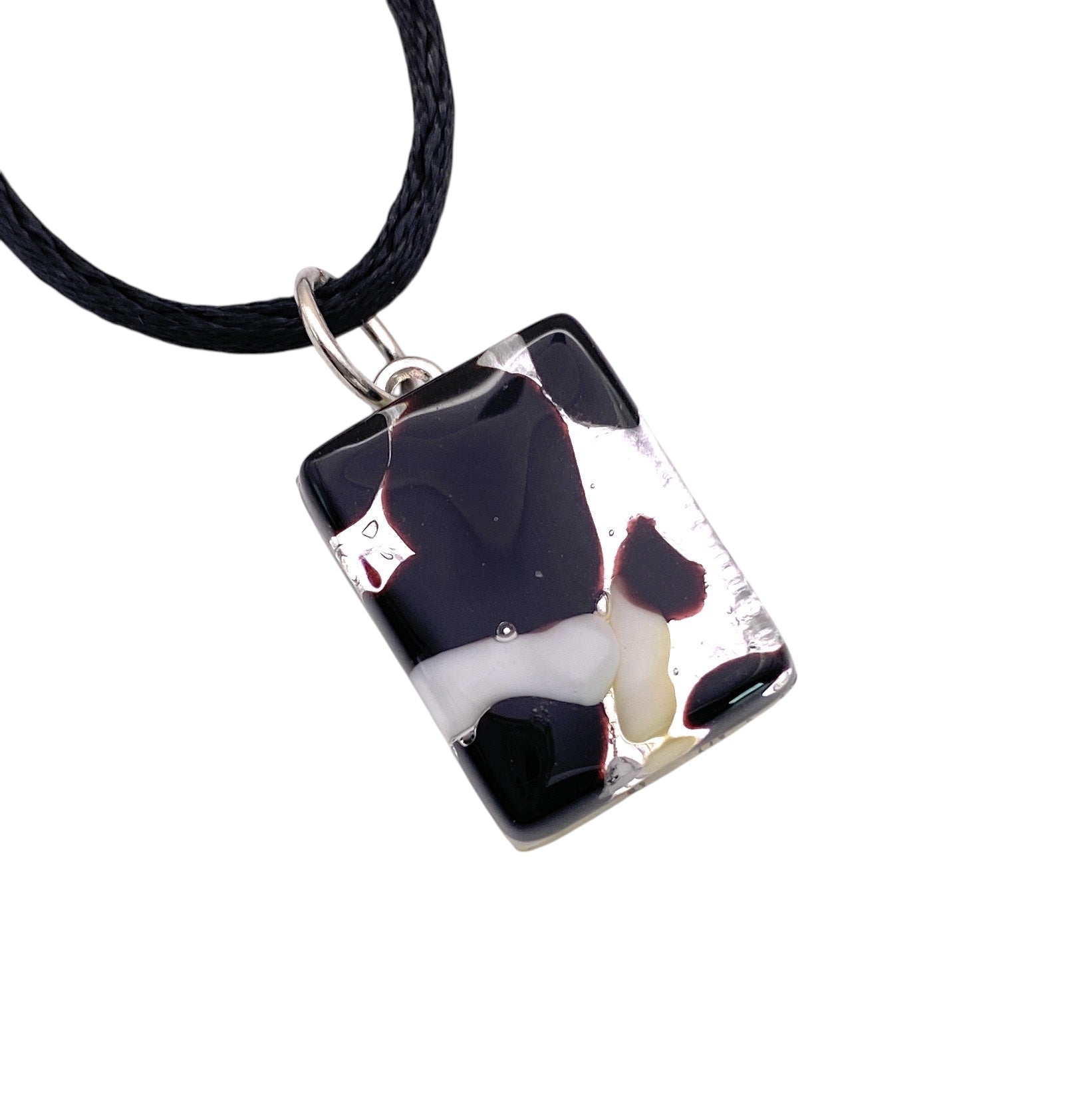 The Murano Passion pendant necklace showcases a dainty 2cm x 1.5cm Murano Glass Pendant, Black on Silver Leaf design, set on a sleek black cord. This exquisite piece of Murano Glass Jewellery includes a Certificate of Authenticity.