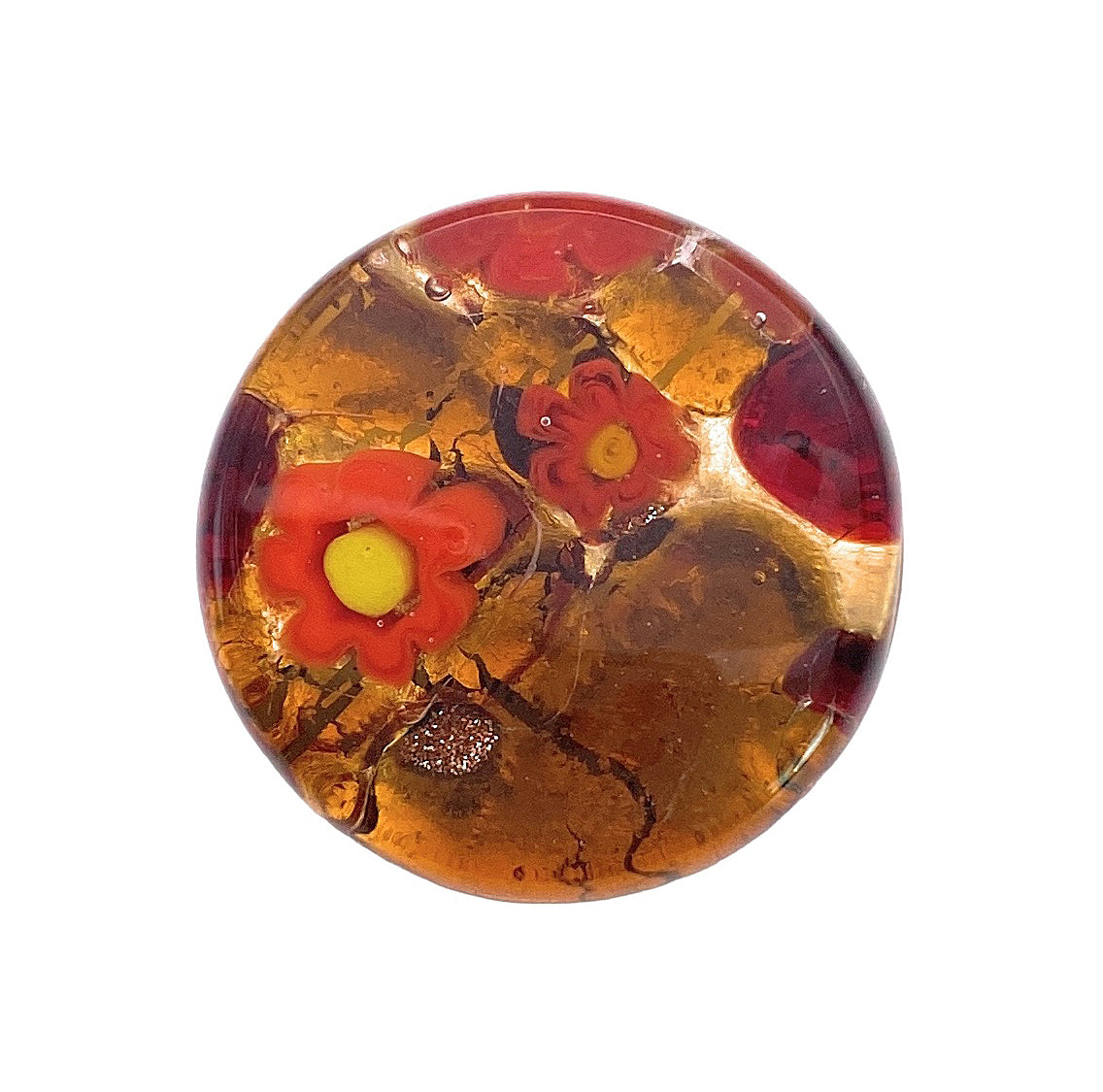 The Murano Passion Brooch features exquisite craftsmanship, showcasing a round amber-colored glass design with embedded red flowers and a central yellow core. Its swirling patterns, crafted in the style of Murano Glass on a gold leaf base, beautifully echo Venetian artistic heritage.