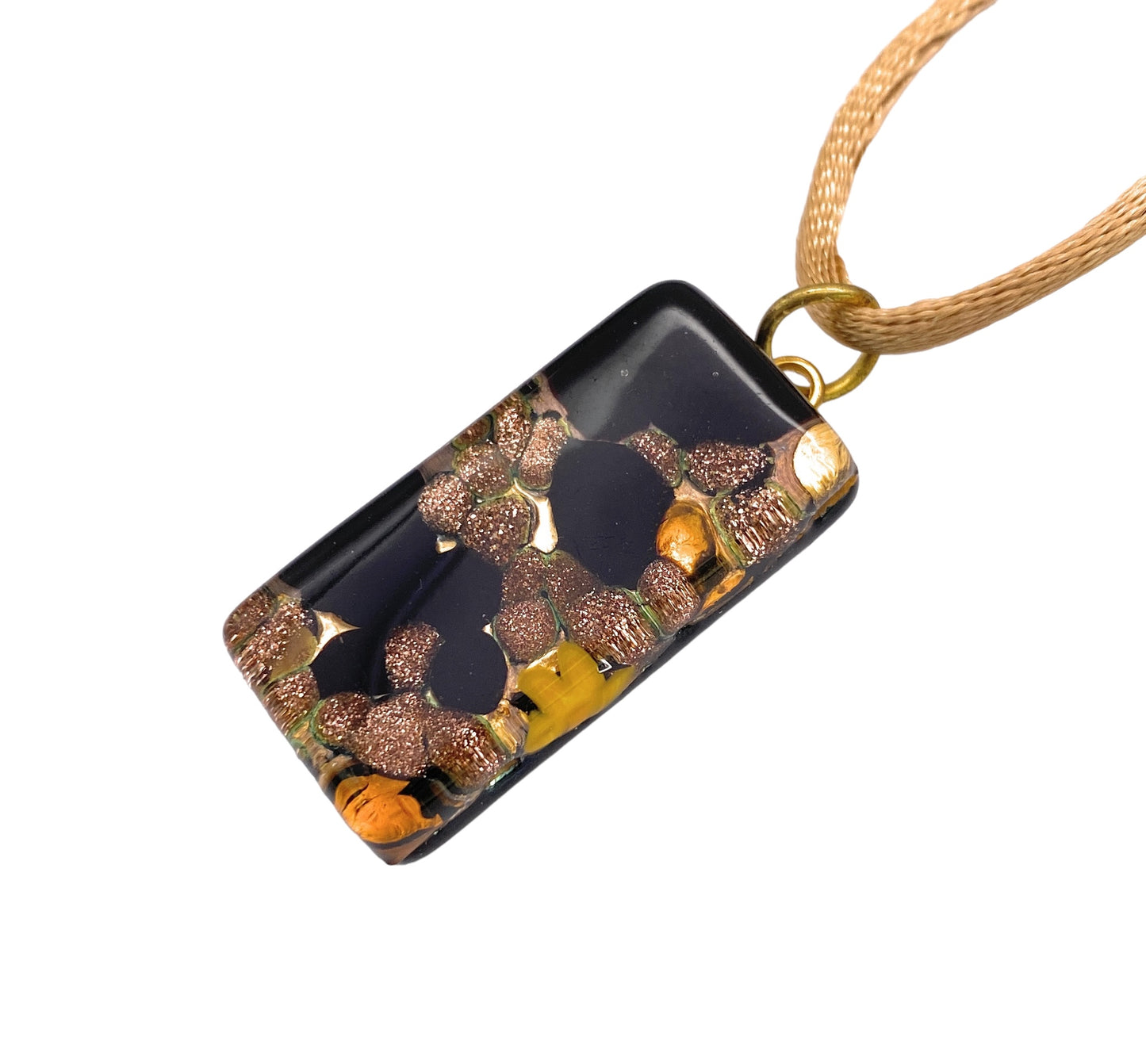 The Murano Glass Pendant by Murano Passion, crafted from Aventurine Gold Glitter Glass in a 3cm x 1.5cm size, features a rectangular shape with a marbled design of gold, bronze, and black colors. It is suspended from a light brown cord and boasts a glossy finish that highlights the exquisite craftsmanship synonymous with elegant Murano Glass Jewellery.