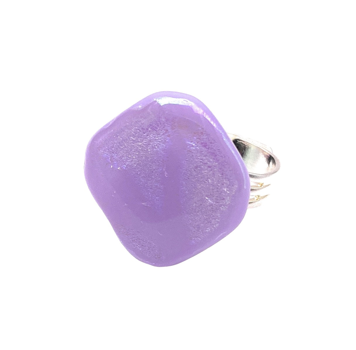 An adjustable handmade glass ring by Calon Glass, showcasing a large smooth purple stone with an irregular shape and glossy finish, highlights the elegance of their Lilac Dichroic Glass design.