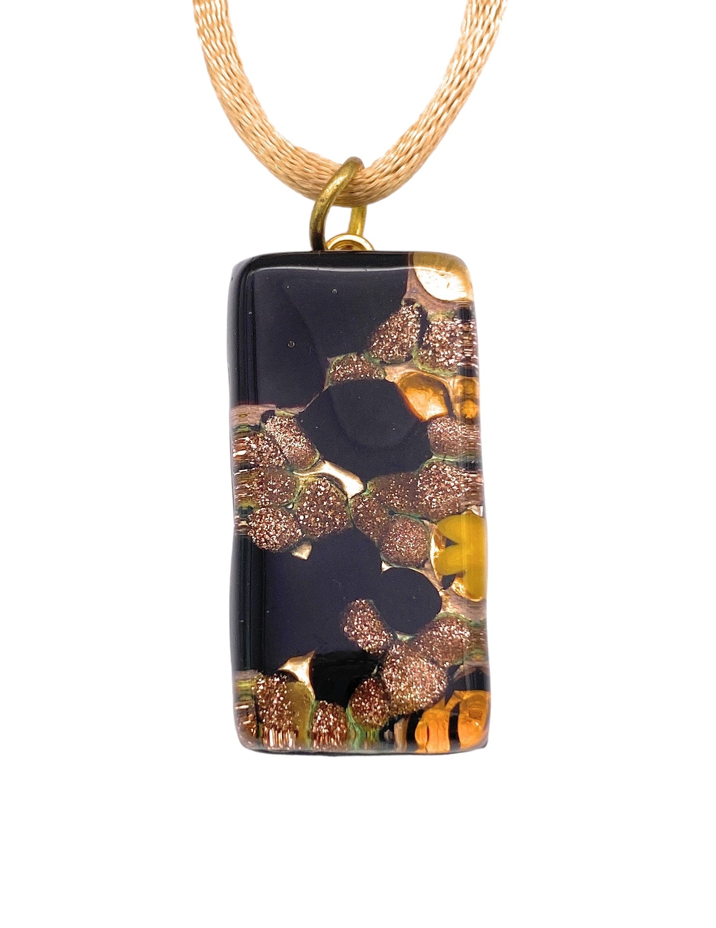 The Murano Passion Pendant, crafted from Aventurine Gold Glitter Glass, features a rectangular design measuring 3cm by 1.5cm with a glossy black backdrop that highlights an abstract pattern of copper and bronze accents, all suspended from a gold woven chain.