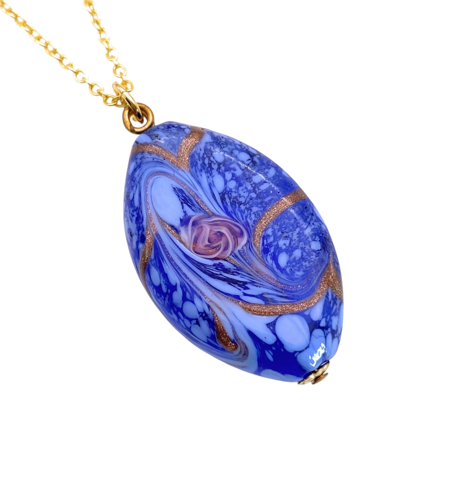 A teardrop-shaped Murano Glass Pendant by Murano Passion, featuring a swirling blue and gold design, is elegantly suspended from a delicate gold chain.