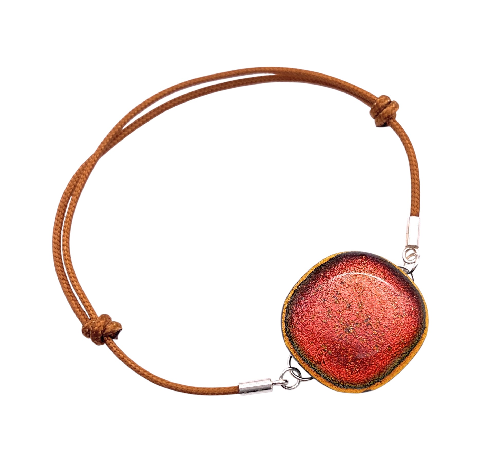 The Calon Glass CGBR3 is a handmade brown cord bracelet with an adjustable knot design, featuring a unique 2cm glass centerpiece in burnt orange textured with red and golden edges.