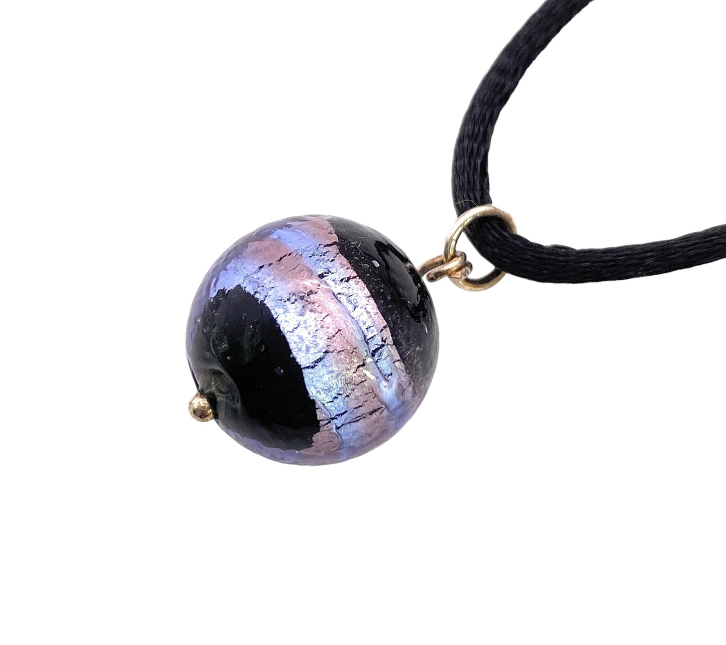 Close-up of a Murano Passion pendant, showcasing a 1.5cm handmade glass bead with an iridescent finish and a black stripe, elegantly suspended on a black cord. The bead shimmers in captivating shades of blue and purple as it catches the light.