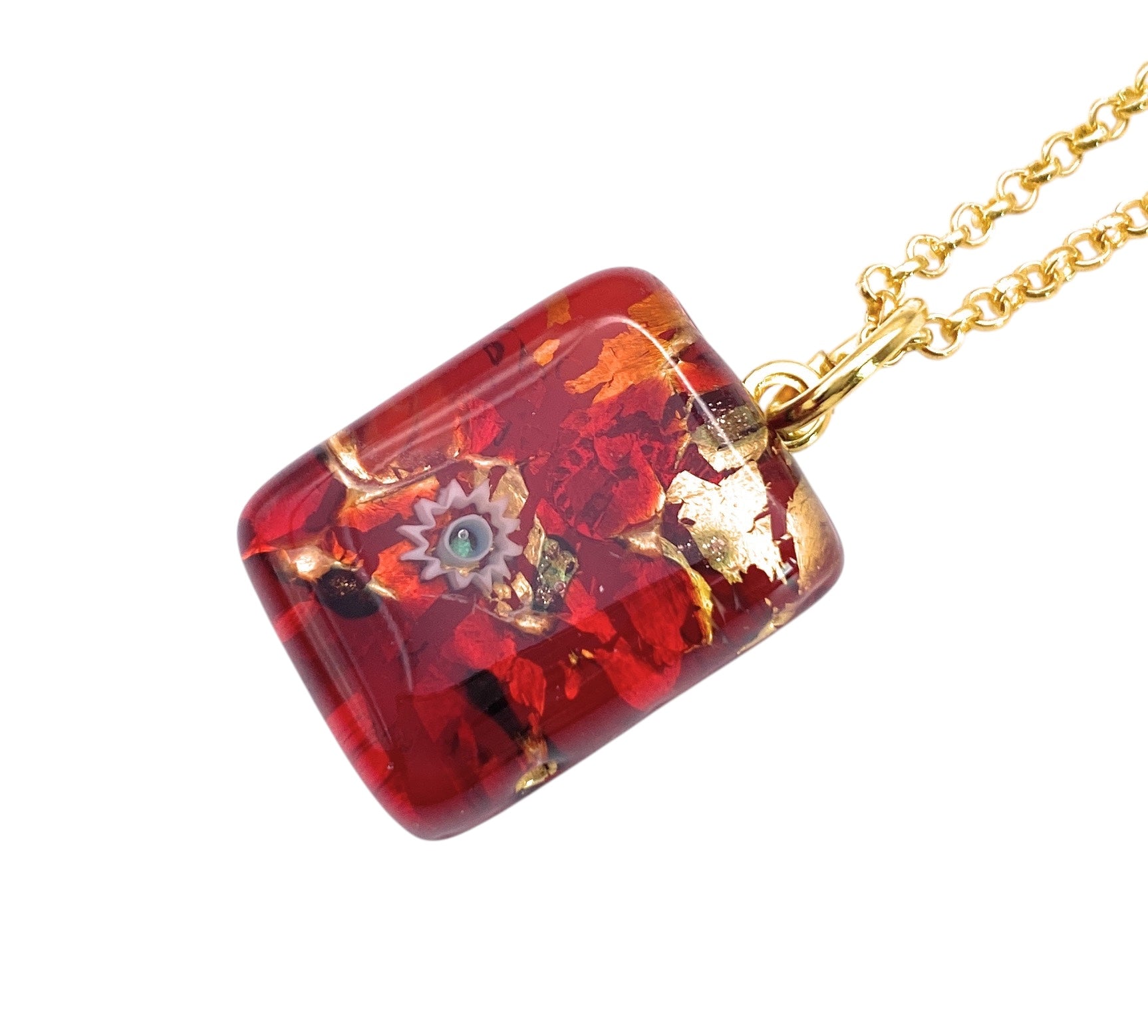 This exquisite Murano Passion glass pendant features a multicolored resin charm adorned with embedded red and gold flakes, complemented by a delicate gray spiral. The dainty piece measures 2cm x 1.5cm and is elegantly suspended from a gold chain, exuding sophistication. For your peace of mind, it comes with a Certificate of Authenticity.