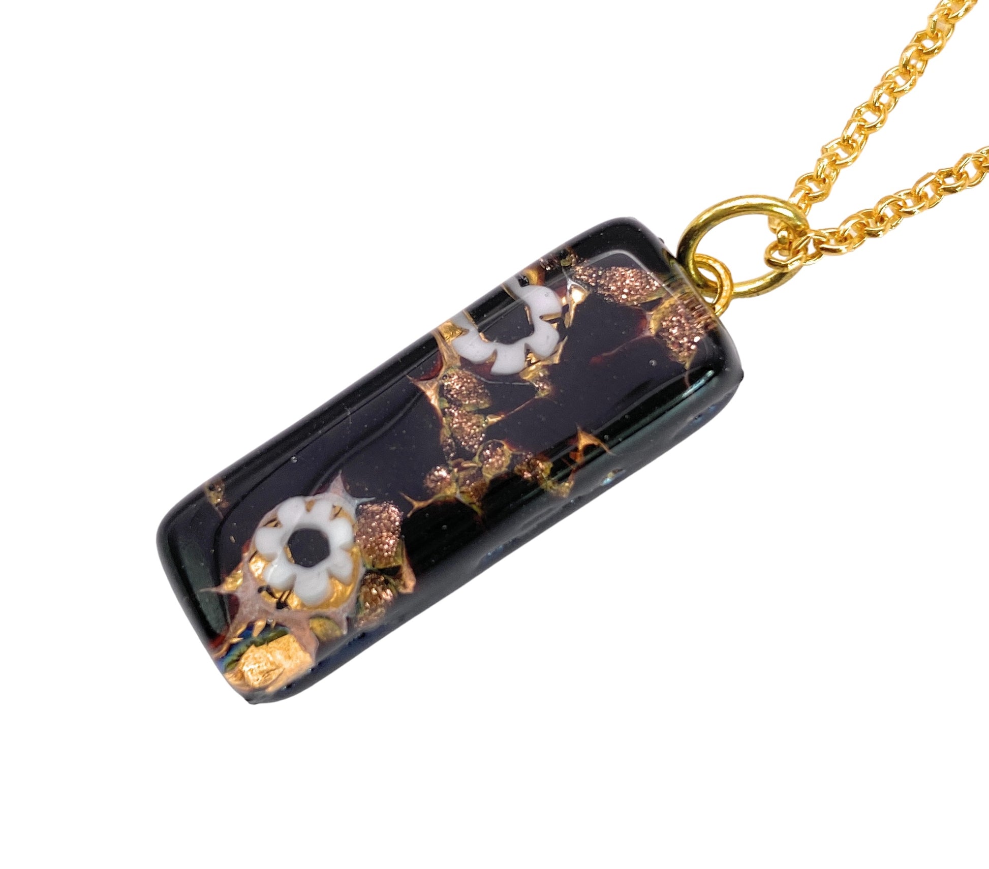 Presenting the exquisite Murano Glass Pendant - 3cm x 1cm Millefiori Flowers on Gold Leaf (MGPL8) by Murano Passion, a breathtaking rectangular black pendant embellished with gold leaf and intricate white floral designs, elegantly suspended from a gold chain. Featuring an accompanying Certificate of Authenticity, this piece exemplifies the sophisticated charm of fine Murano Glass Jewellery.