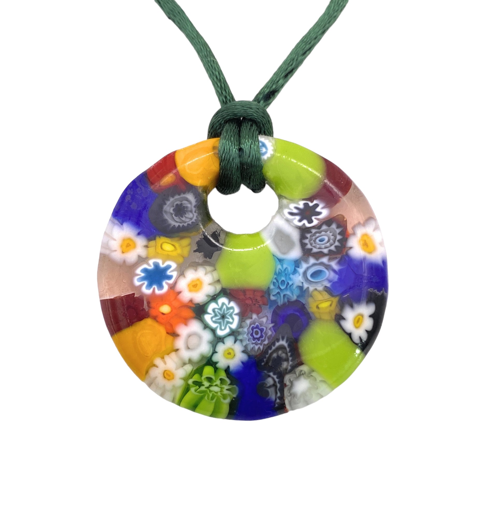 Experience the exquisite craftsmanship of Murano Passion with the Murano Glass Pendant, Millefiori Flower Pendant - 4cm. This round, multicolored piece features intricate floral and geometric patterns, suspended from a dark green cord. The pendant is adorned with striking hues of blue, green, orange, red, and white in a stunning mosaic design that epitomizes the unique allure of Millefiori Murano Jewellery.