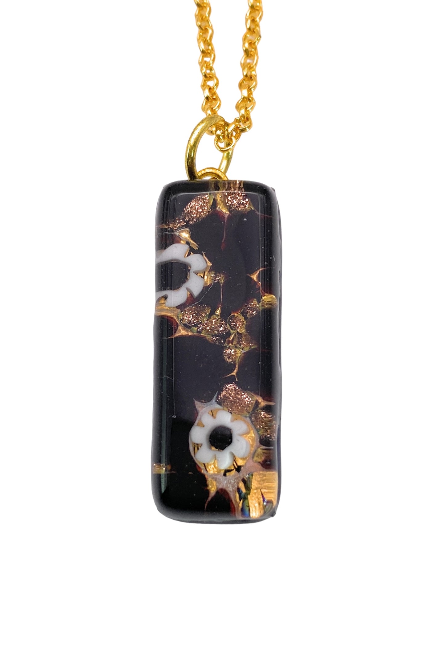 A rectangular Murano Glass Pendant by Murano Passion, measuring 3cm x 1cm and decorated with Millefiori flowers on a gold leaf, hangs elegantly from a gold chain against a white background.