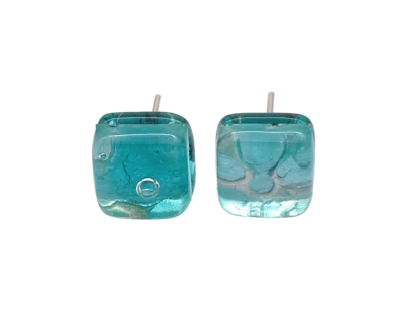 These Murano Glass Earrings by Murano Passion feature dainty 8mm blue glass studs with a marbled texture and small bubbles inside, set on silver posts. Each pair is handmade, offering a unique touch.