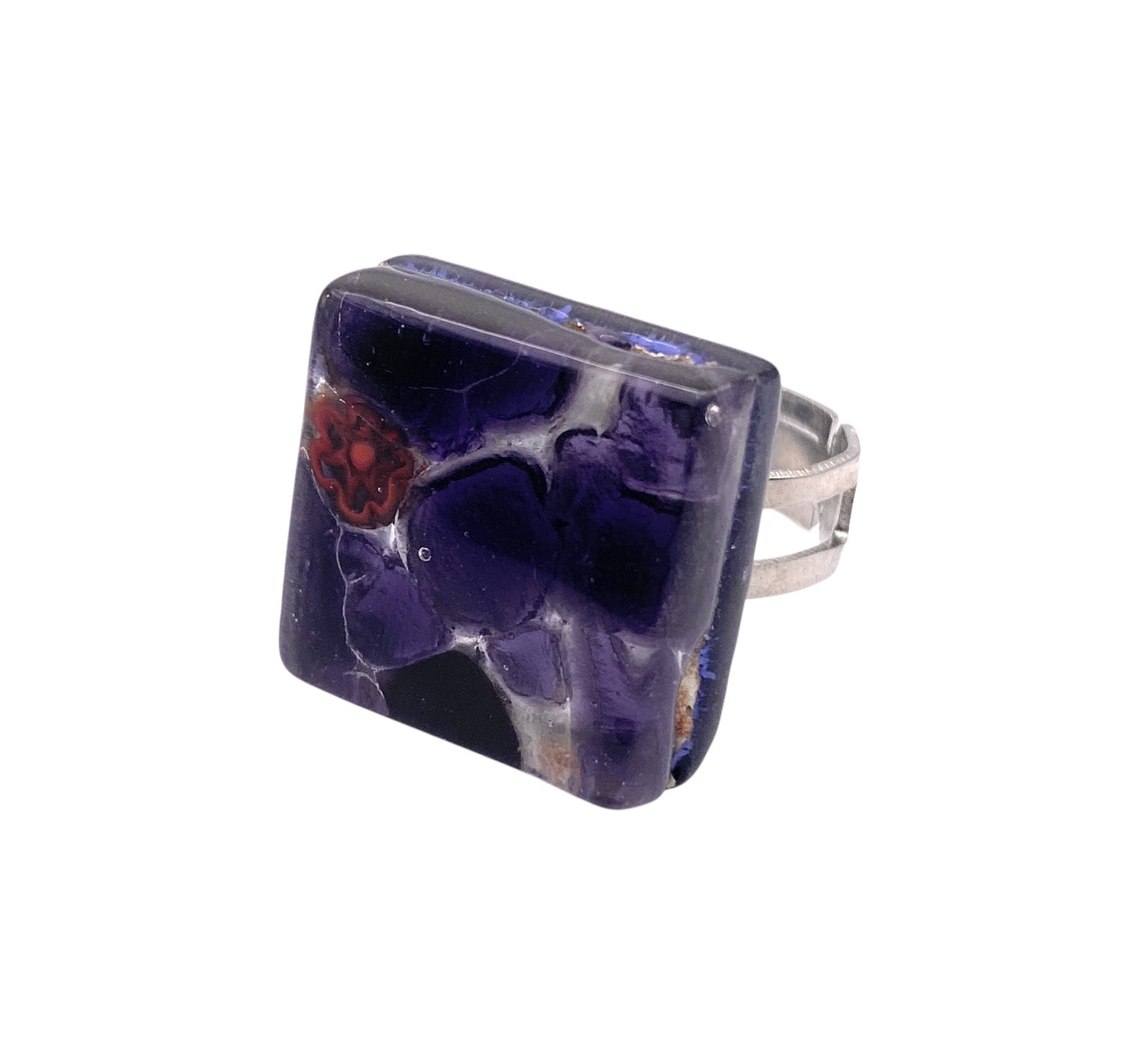 The Murano Passion "Murano Glass Ring made with Millefiori on Silver Leaf - 2cm x 2cm (MGR1)" features a large, square glass centerpiece in deep purple with abstract red-orange swirls. Handmade in Venice, it embodies authentic Italian craftsmanship.